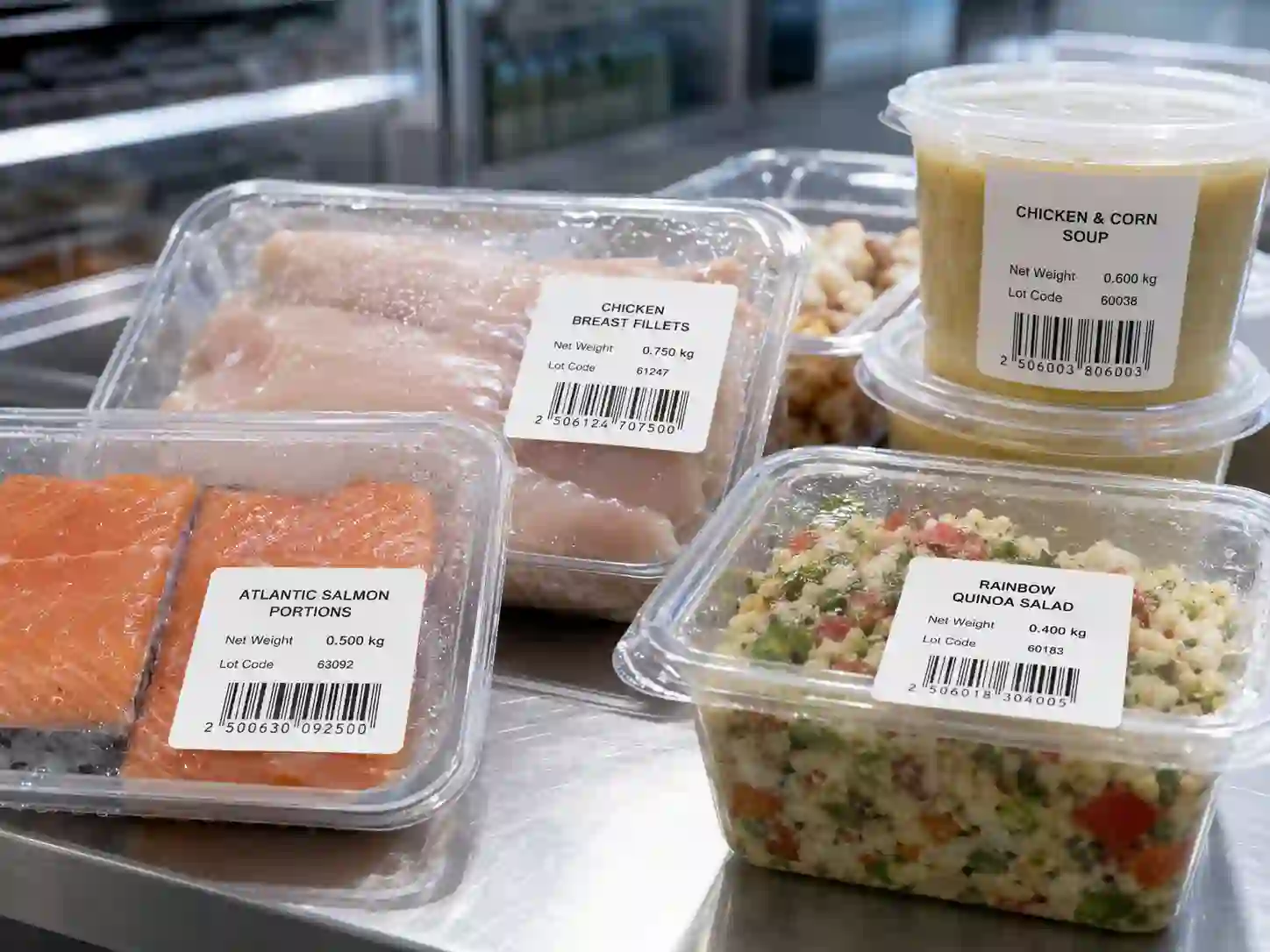 hypaper-cold-chain-thermal-labels-refrigerated-food-containers Hy paper cold-chain thermal labels applied on packaged salmon, poultry, and deli containers.
