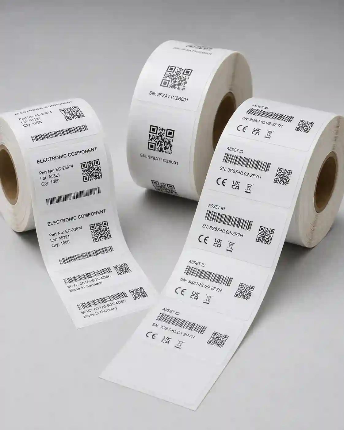 hypaper-qr-code-serial-number-compliance-electronics-labels Rolls of Hy paper custom printed electronics serial number, QR code, and CE compliance labels.