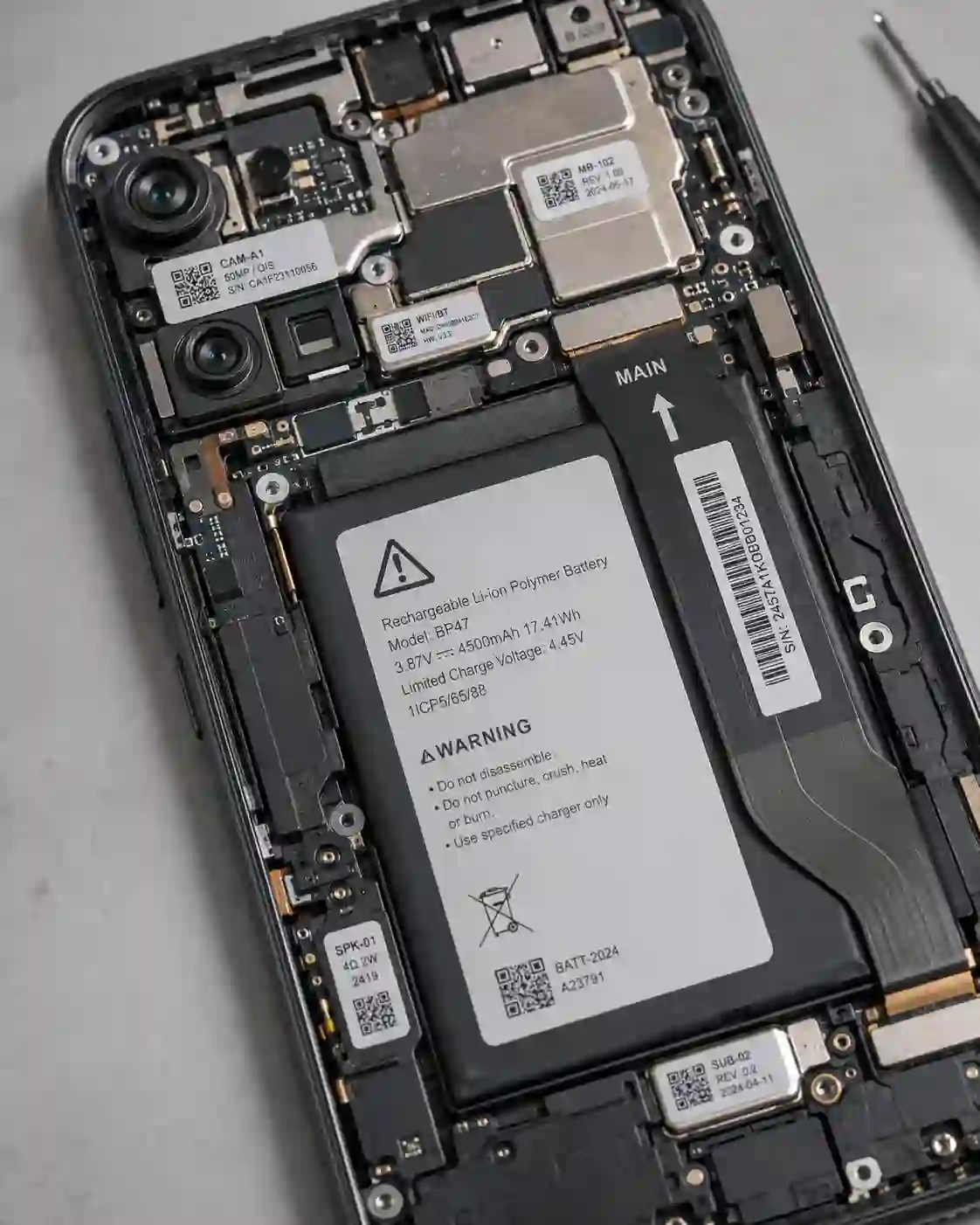 hypaper-smartphone-battery-serial-number-sticker-label Precision Hy paper barcode and warning labels on smartphone battery and internal circuit components.